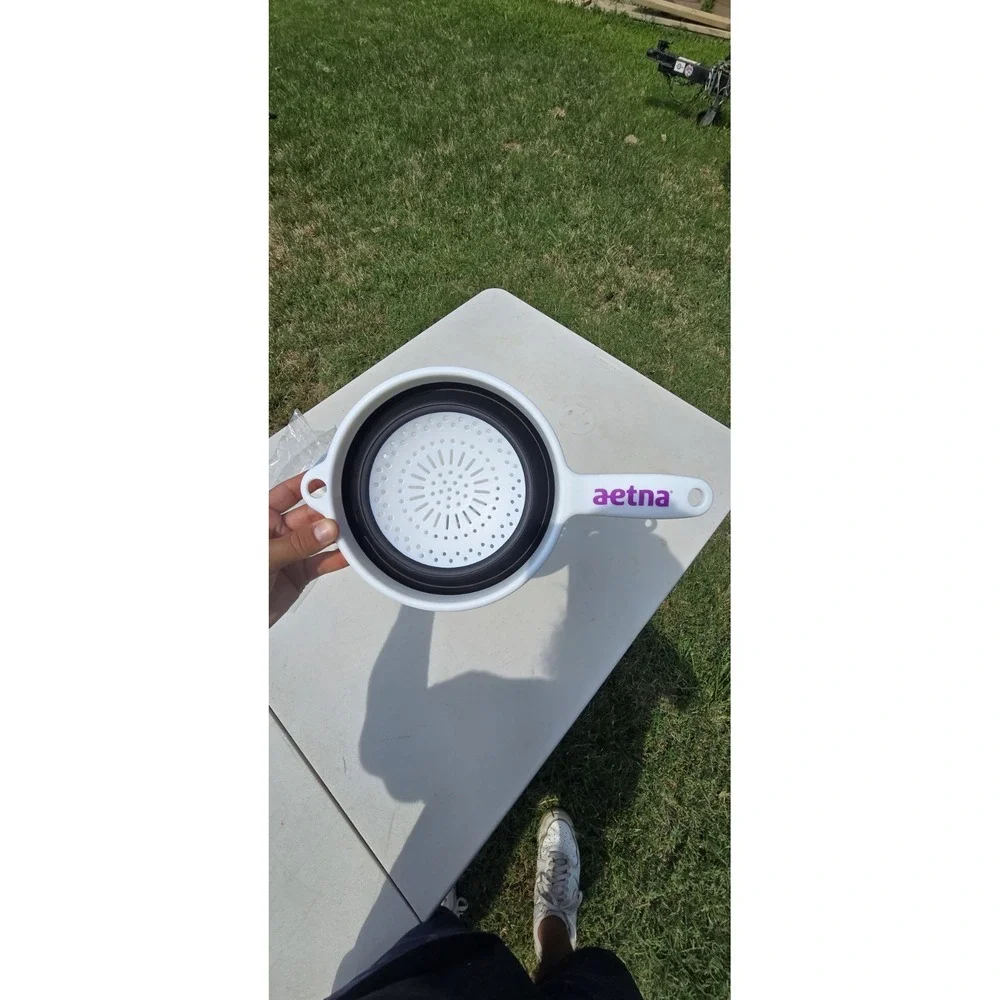 white and black collapsible kitchen strainer or colander Aetna branded handle